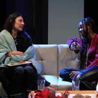 Two women sitting on a couch talking